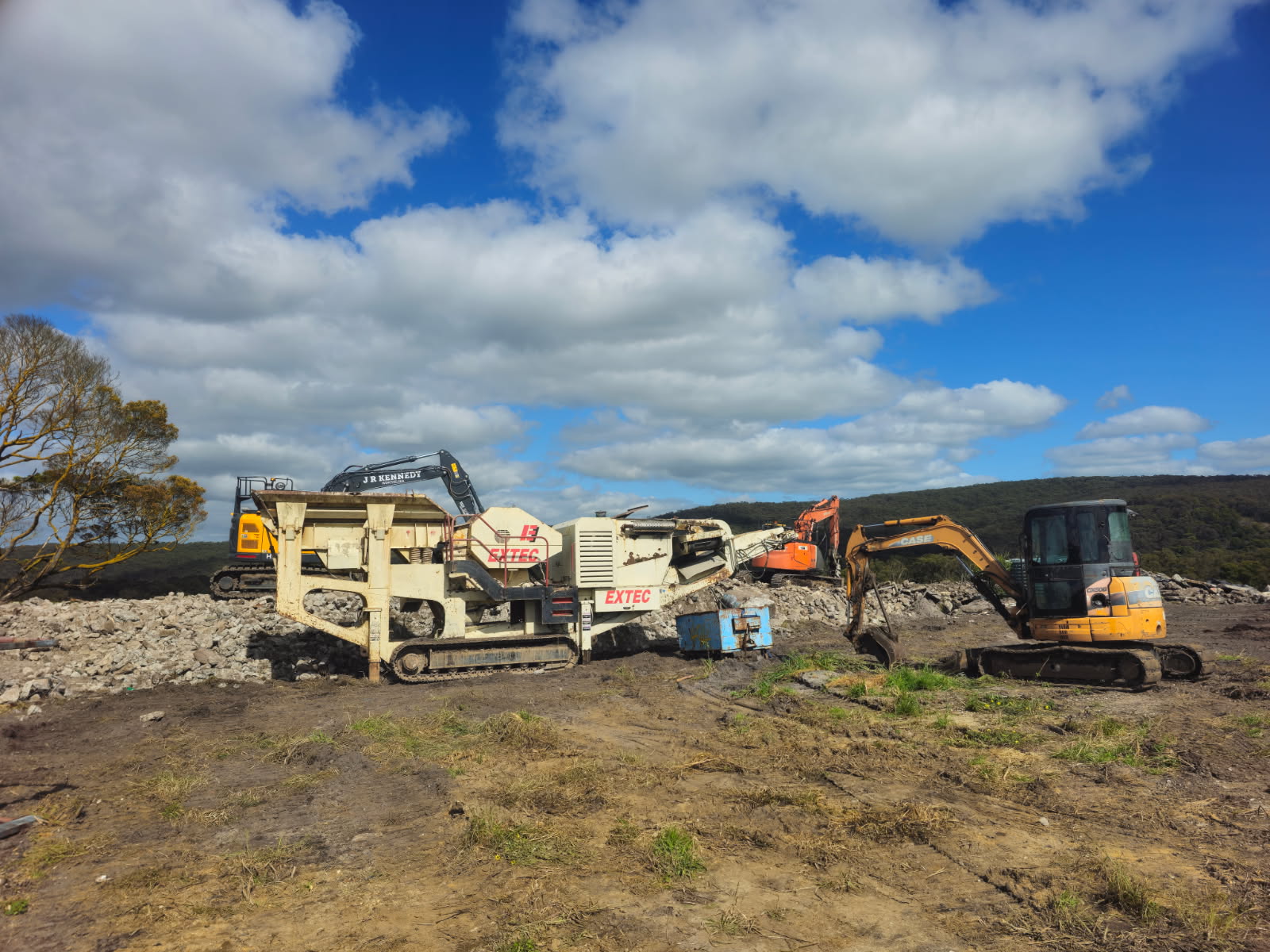 J.R. Kennedy excavators and mobile crusher recycling concrete on site